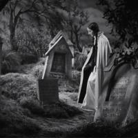 A black-and-white image of a woman standing amongst headstones in a Jewish cemetary.